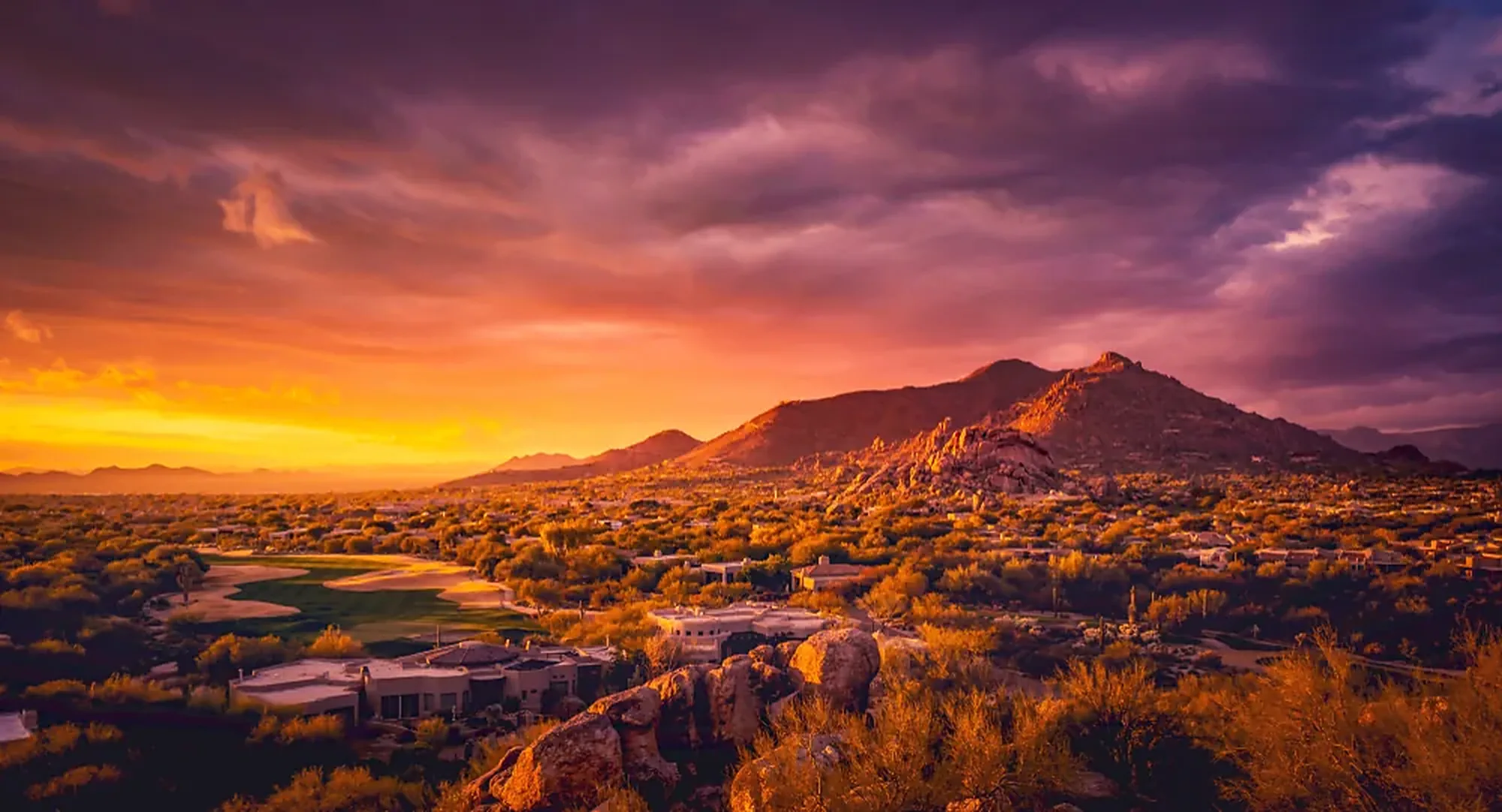 Scottsdale desert ridgeline glowing under a dramatic sunset sky